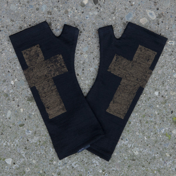 Black merino wool fingerless gloves with a bronze gothic cross print, handmade in Dunedin New Zealand by Kate Watts.