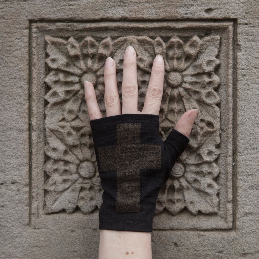 Short black merino wool fingerless gloves with a bronze gothic cross print, handmade in Dunedin New Zealand by Kate Watts.