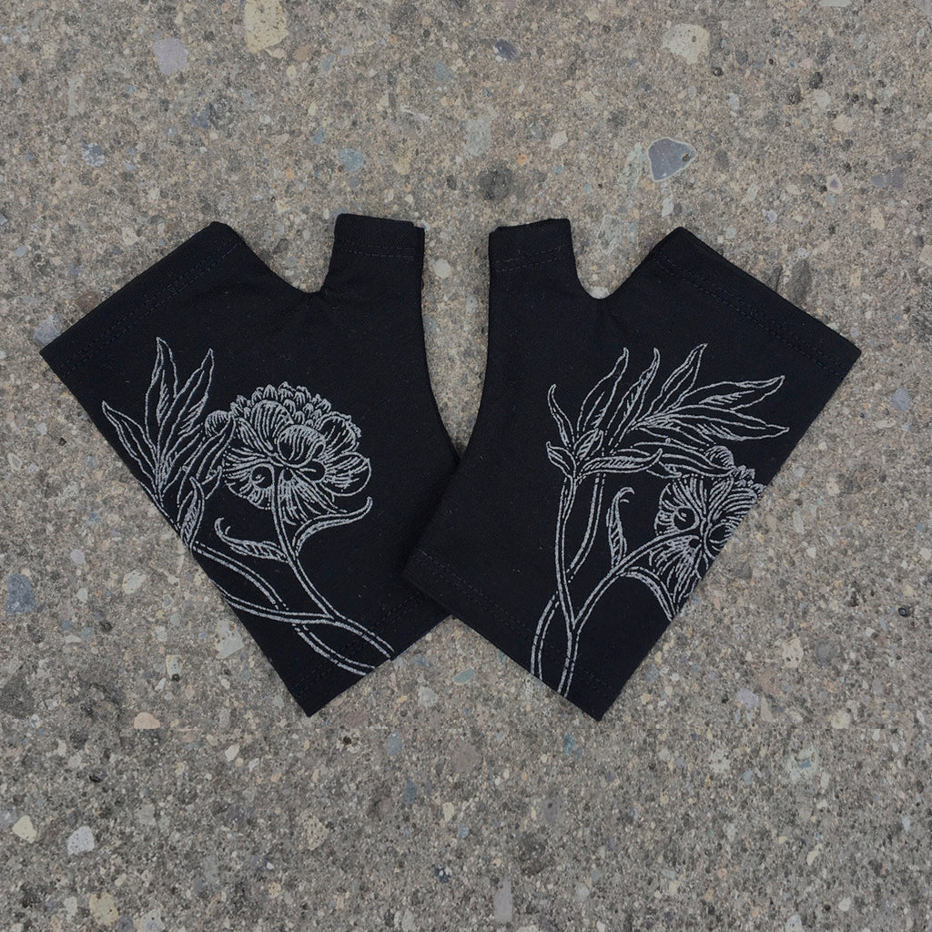 Black fine merino wool fingerless gloves with a silver peony print, handmade in Dunedin New Zealand by Kate Watts.