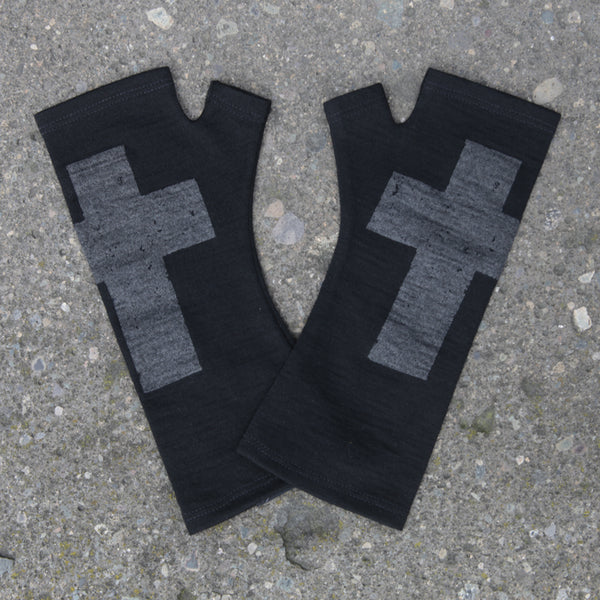 Black merino wool fingerless gloves with a silver gothic cross print, handmade in Dunedin New Zealand by Kate Watts.