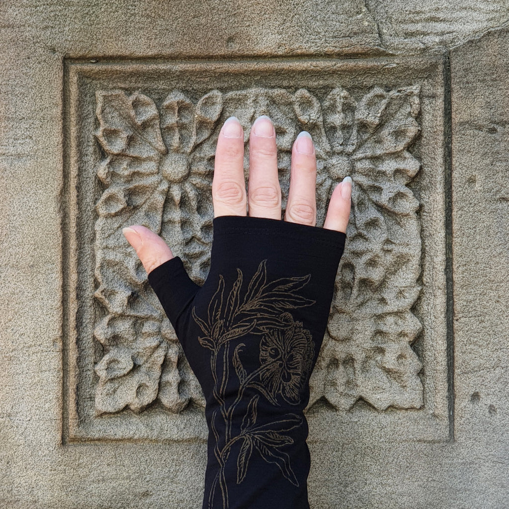 Women’s black winter fine merio wool fingerless mittens, perfect for cold weather. Dunedin made black and gold floral print evening arm warmers. All of our orders come gift wrapped
