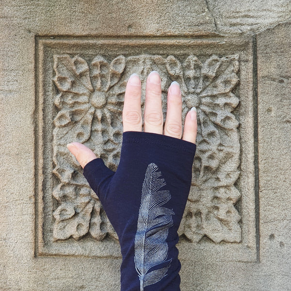 Dark navy blue merino fingerless gloves with a silver feather print, handmade in Dunedin New Zealand by Kate Watts.