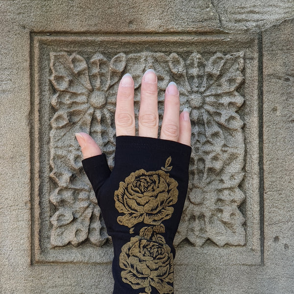 Black merino fingerless gloves with a gold rose print, handmade in Dunedin New Zealand by Kate Watts.