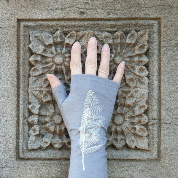 Pale silver grey merino fingerless gloves with a feather print, handmade in Dunedin New Zealand by Kate Watts.